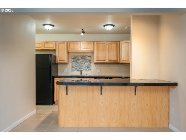 a kitchen with stainless steel appliances granite countertop a sink a stove and a microwave