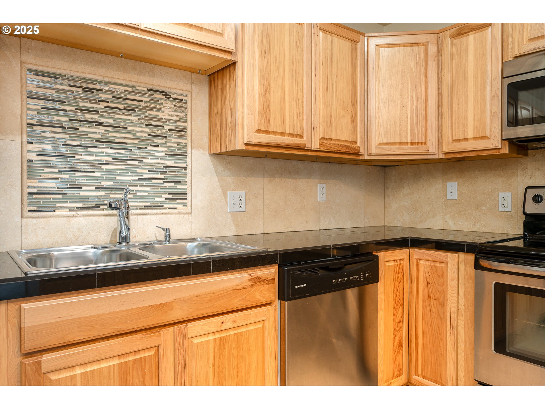 10090 Southwest Beaverton Hillsdale Highway, Unit 16 Beaverton, OR 97005 - Photo 24 of 39 a kitchen with stainless steel appliances granite countertop a sink and a microwave