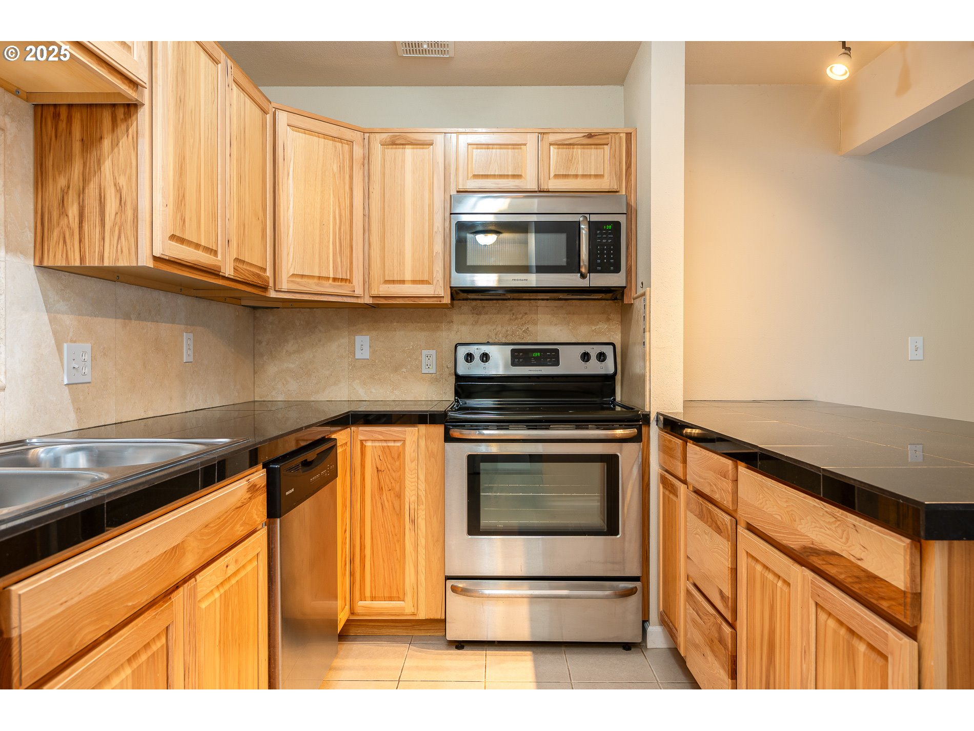 10090 Southwest Beaverton Hillsdale Highway, Unit 16 Beaverton, OR 97005 - Photo 25 of 39 a kitchen with stainless steel appliances granite countertop a stove and a microwave