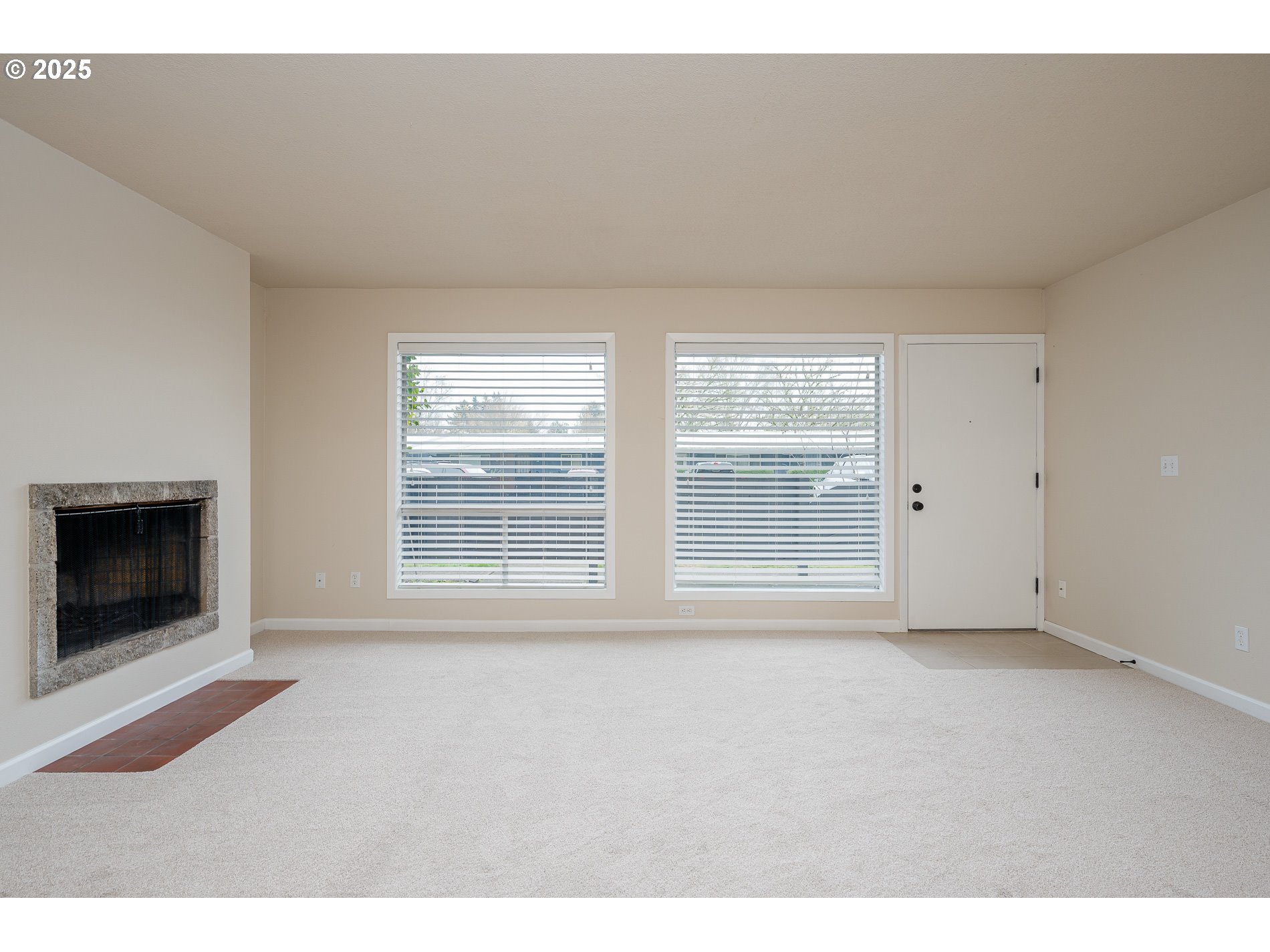 10090 Southwest Beaverton Hillsdale Highway, Unit 16 Beaverton, OR 97005 - Photo 3 of 39 a view of an empty room with a window and fire place