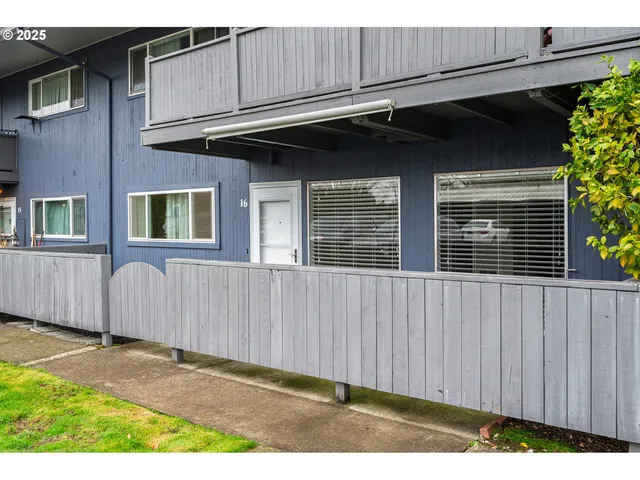 a view of a house with wooden fence