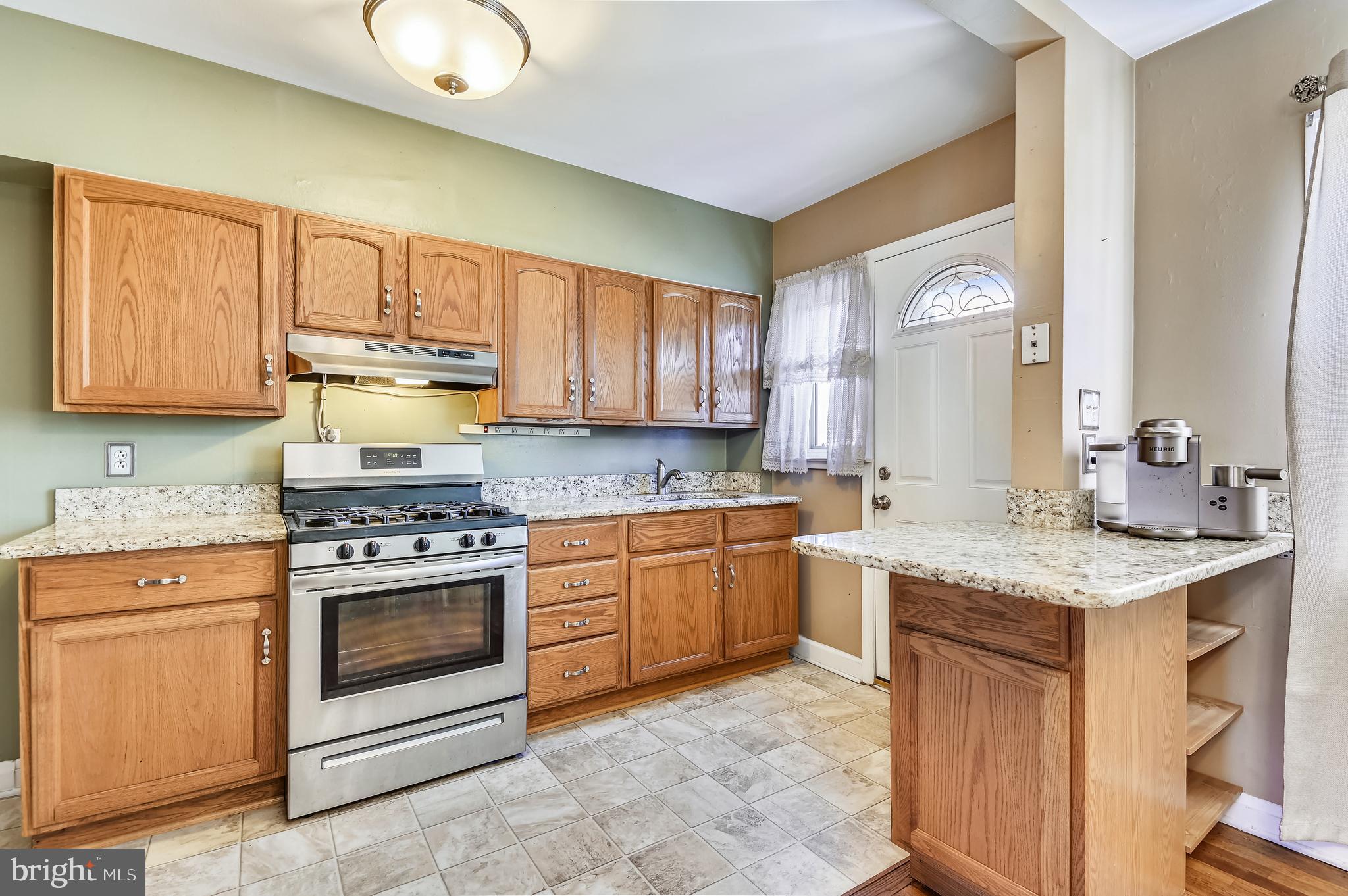 3409 North Point Road Dundalk, MD 21222 - Photo 14 of 36 a kitchen with stainless steel appliances granite countertop a stove sink and cabinets