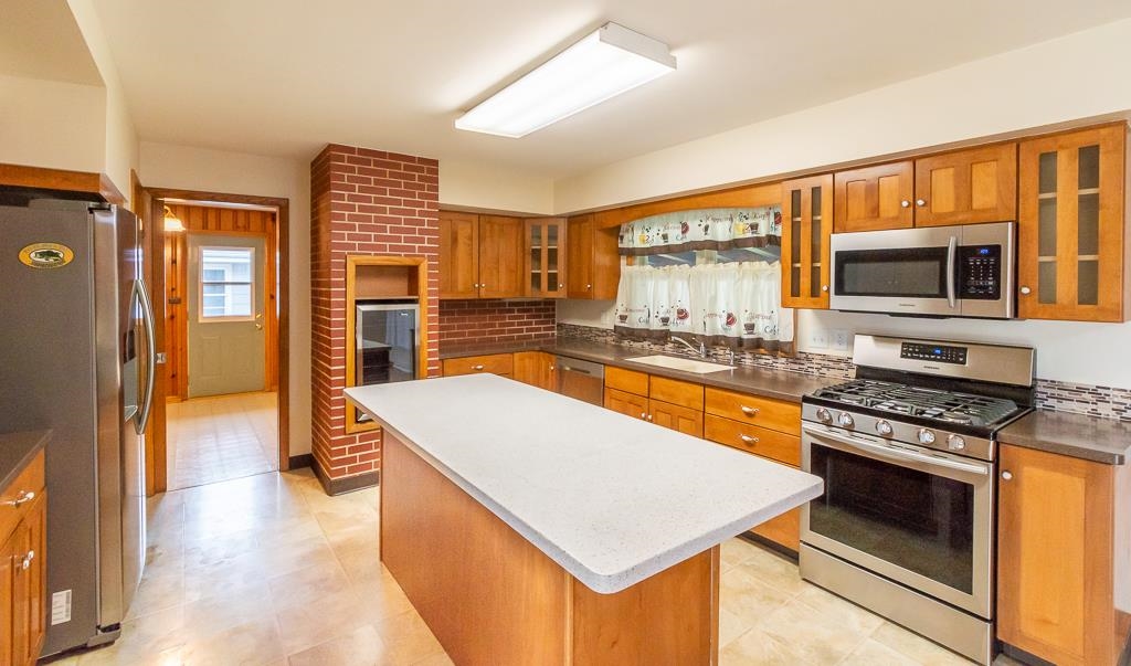 1094 North 3rd Street Rochelle, IL 61068 - Photo 5 of 24 a kitchen with stainless steel appliances a stove sink microwave and refrigerator