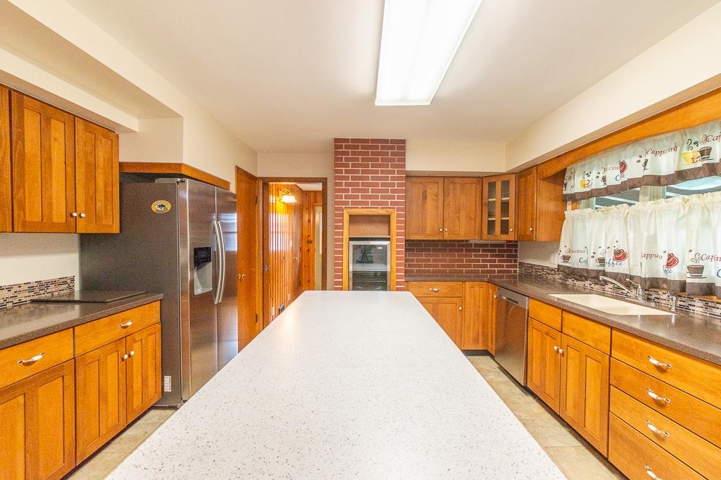1094 North 3rd Street Rochelle, IL 61068 - Photo 6 of 24 a large kitchen with kitchen island granite countertop a large window and stainless steel appliances
