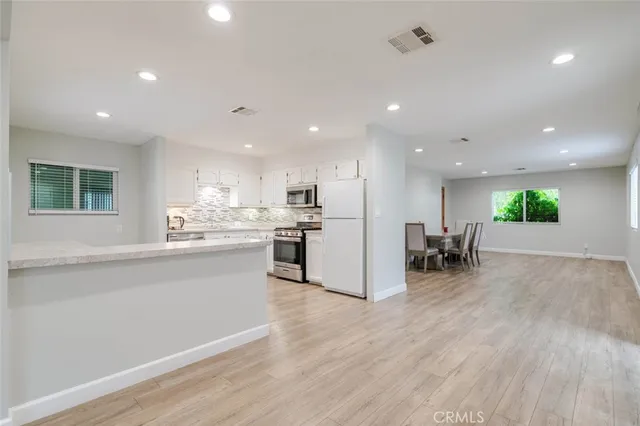 a kitchen with a sink stainless steel appliances and cabinets