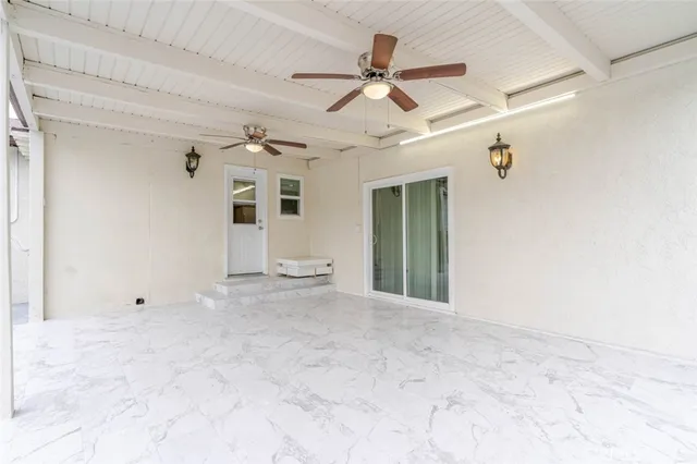 a view of a livingroom with a ceiling fan and window