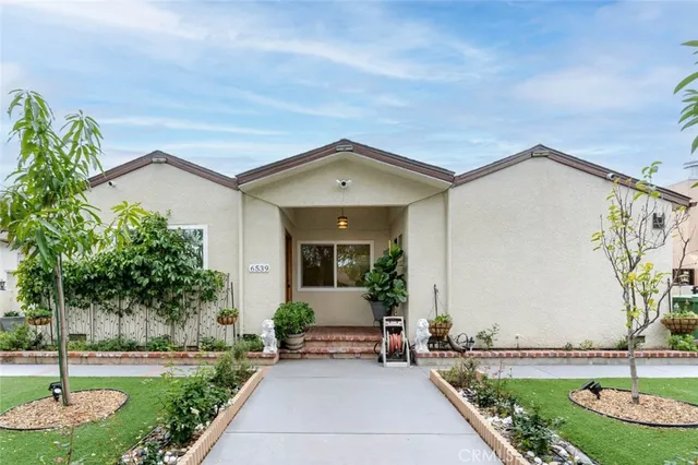 a front view of a house with garden