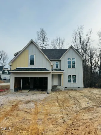 a view of a house with a yard and garage