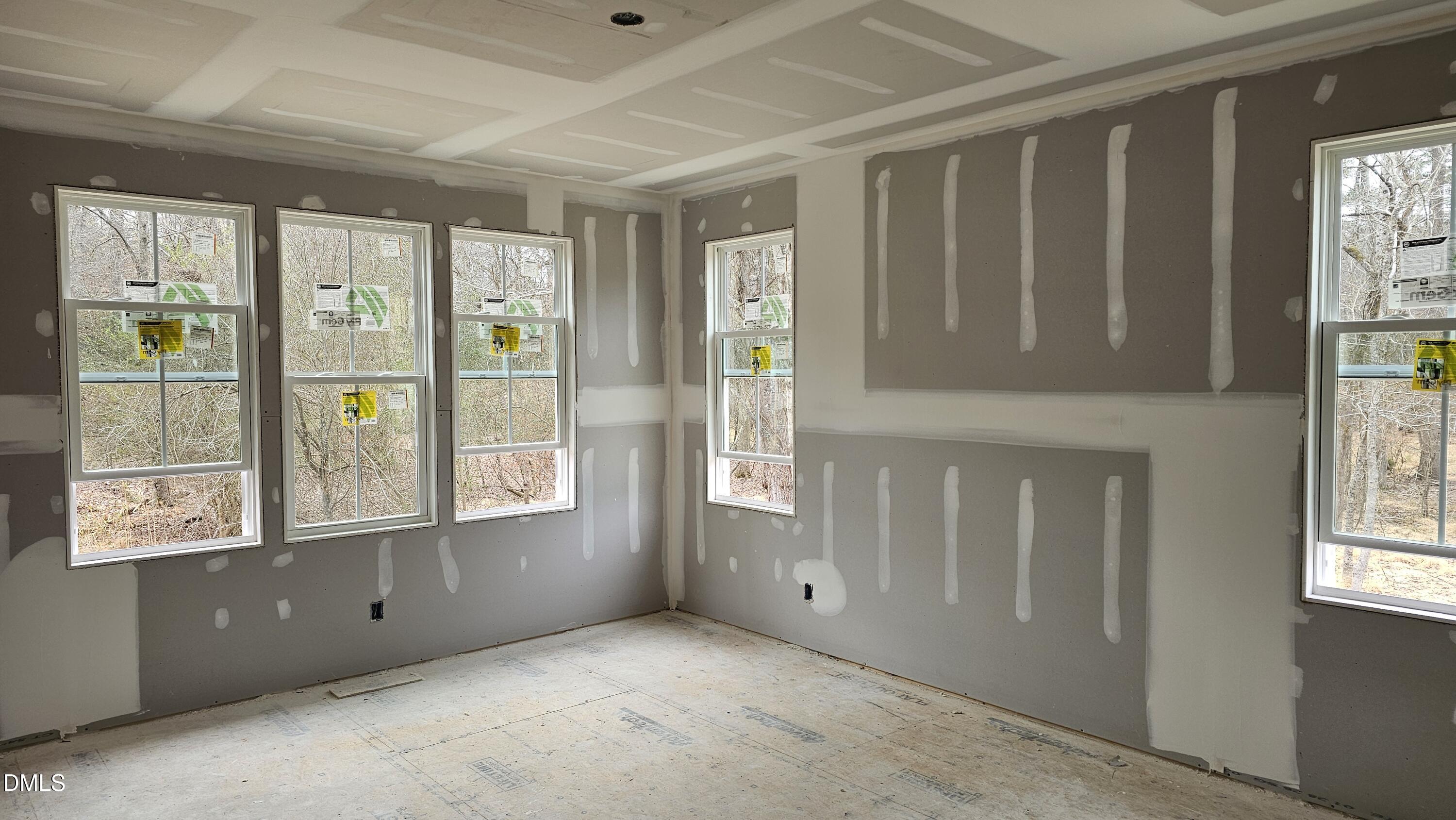 729 Bennett Ridge Court Wake Forest, NC 27587 - Photo 2 of 11 wooden floor in an empty room with a window
