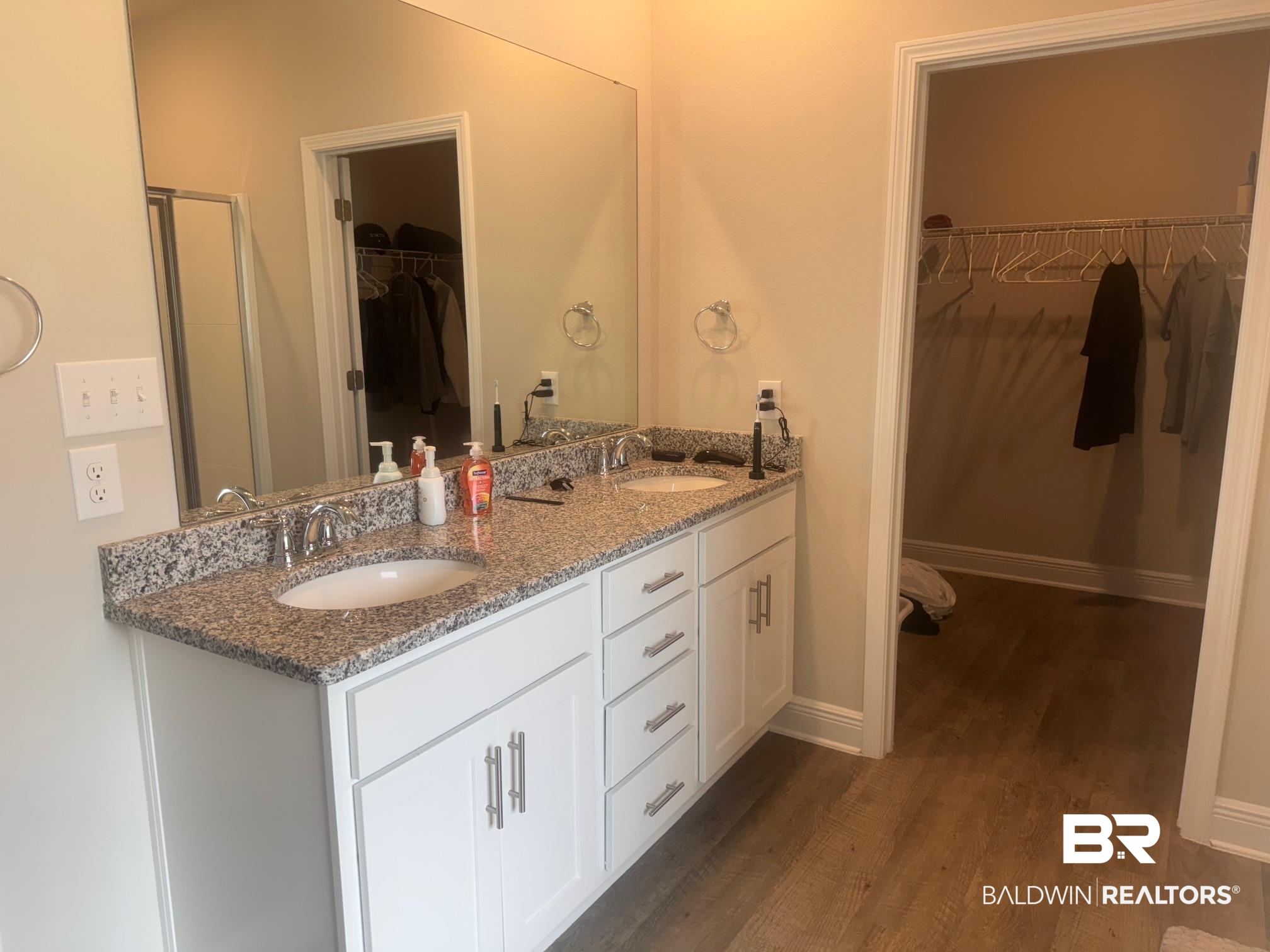 24903 Spectacular Bid Loop Daphne, AL 36526 - Photo 20 of 37 Full bath with double vanity, a spacious closet, wood finished floors, and a shower with door