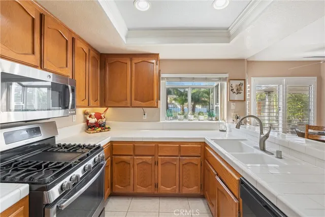 a kitchen with granite countertop a sink stove and cabinets