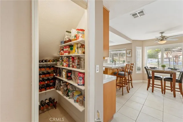 a dining room with lots of furniture and a chandelier