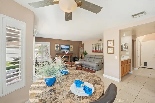 a dining room with furniture a window and a potted plant