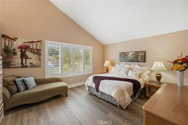 a bedroom with bed couch and window