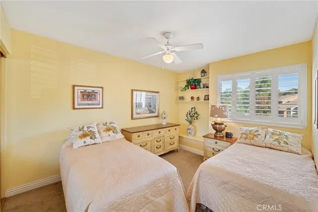a bedroom with two beds and a large window