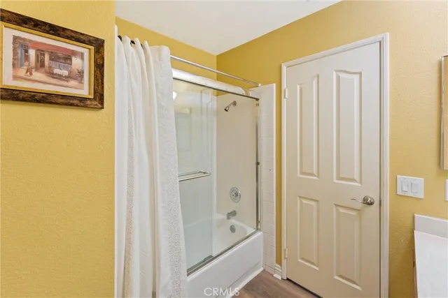 a bathroom with a shower and a glass door
