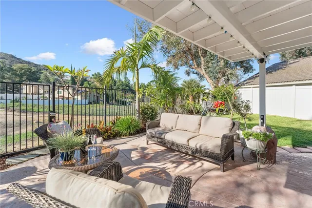 a view of a patio with couches table and chairs and potted plants