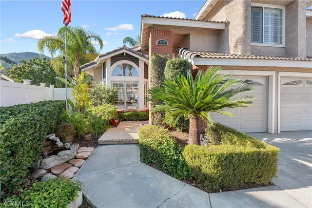 a front view of a house with a garden
