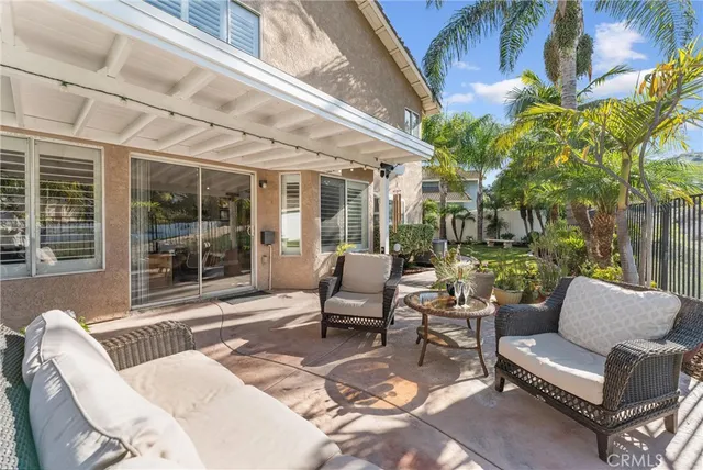a balcony with furniture and a potted plant