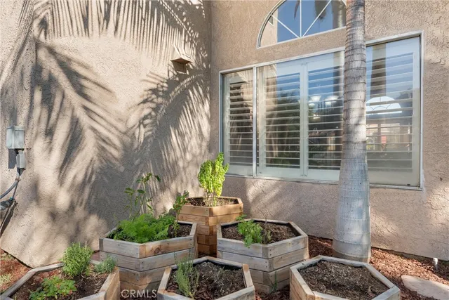 a view of a patio with table and chairs and potted plants