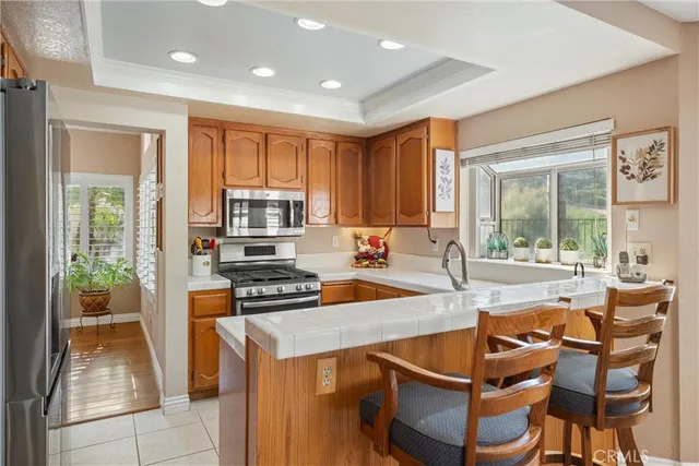 a kitchen with a stove a sink and a refrigerator