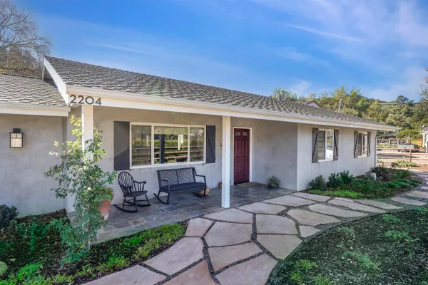a front view of a house with garden