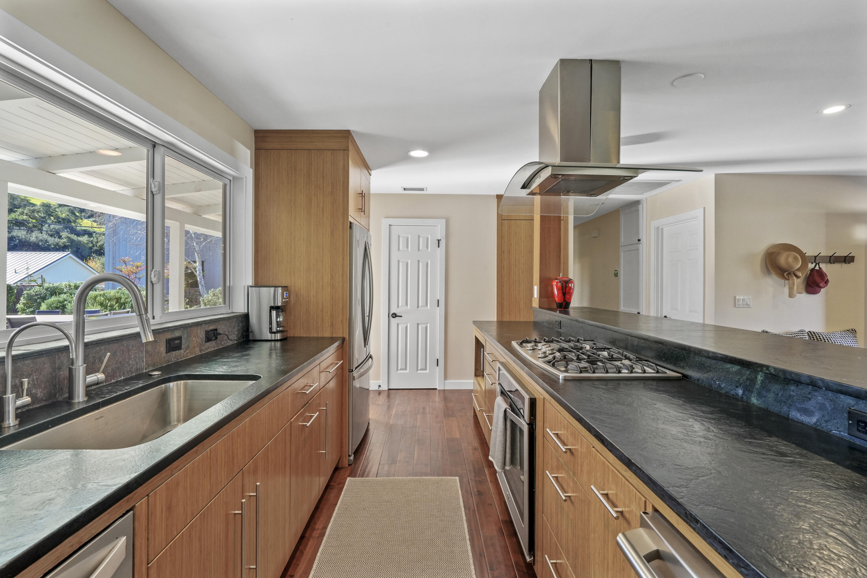 2204 Alamo Pintado Road Solvang, CA 93463 - Photo 6 of 17 a kitchen with granite countertop a sink and a stove top oven