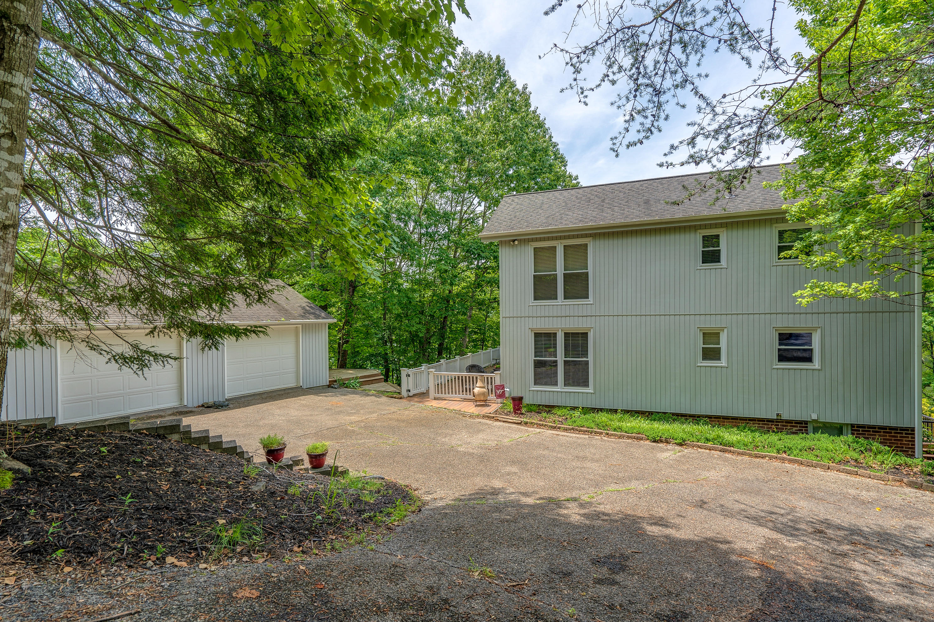 161 Highland Lake Road Union Hall, VA 24176 - Photo 2 of 45 a front view of a house with a yard and garage