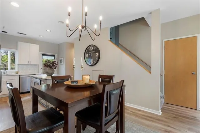 a view of a dining area with furniture and a clock