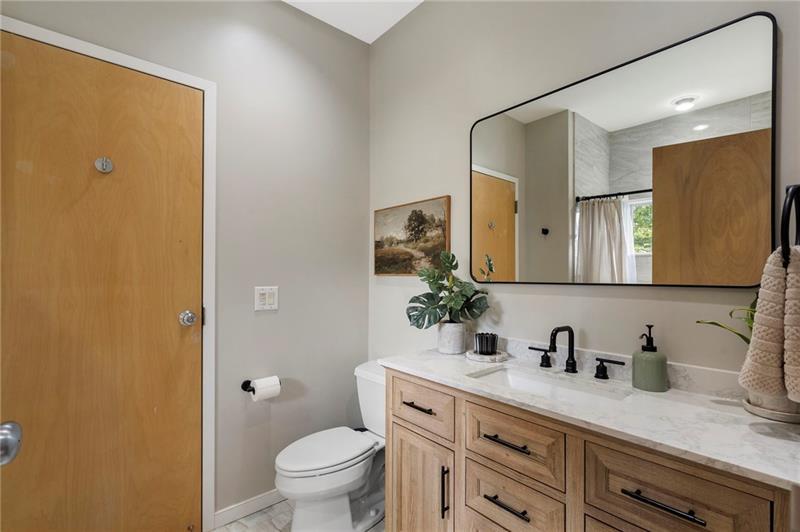 2188 Millennium Way Brookhaven, GA 30319 - Photo 27 of 52 a bathroom with a granite countertop sink a toilet and mirror