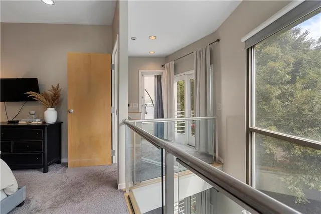 a bedroom with a bed flat screen tv and a window