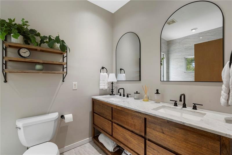 2188 Millennium Way Brookhaven, GA 30319 - Photo 43 of 52 a bathroom with a granite countertop toilet sink and mirror