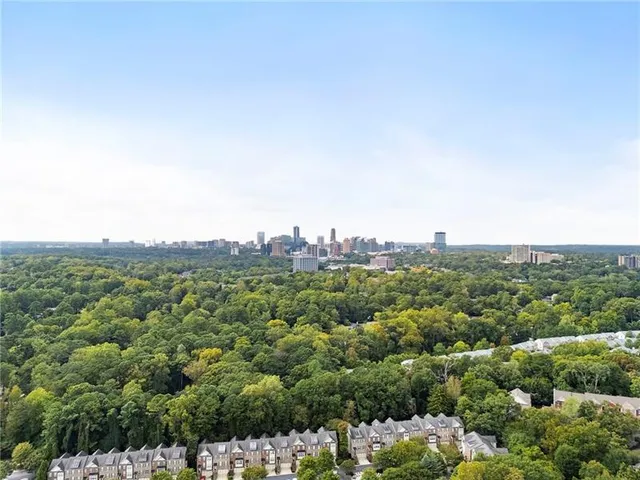 an aerial view of multiple houses with yard