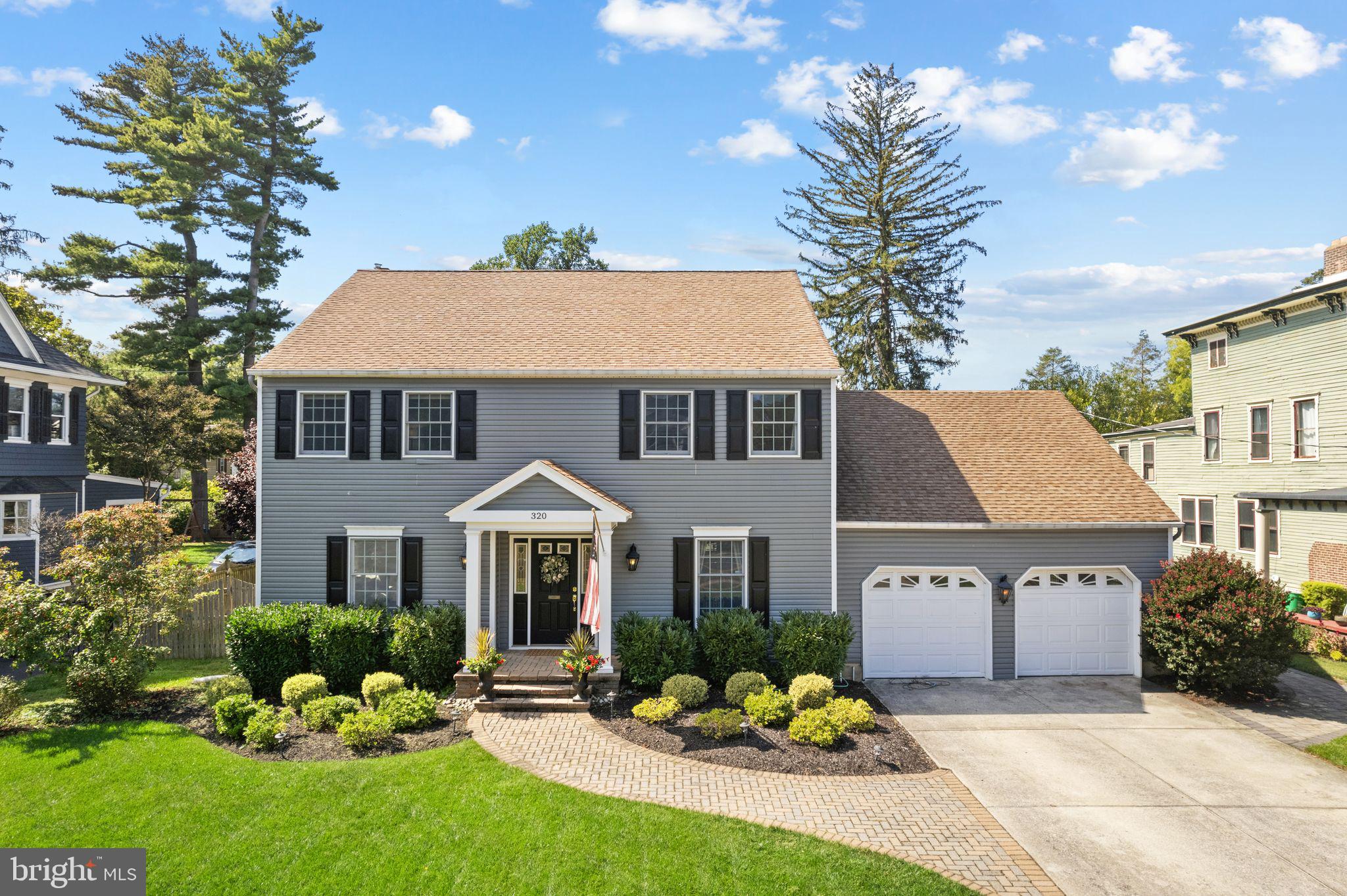 a front view of a house with a yard and porch