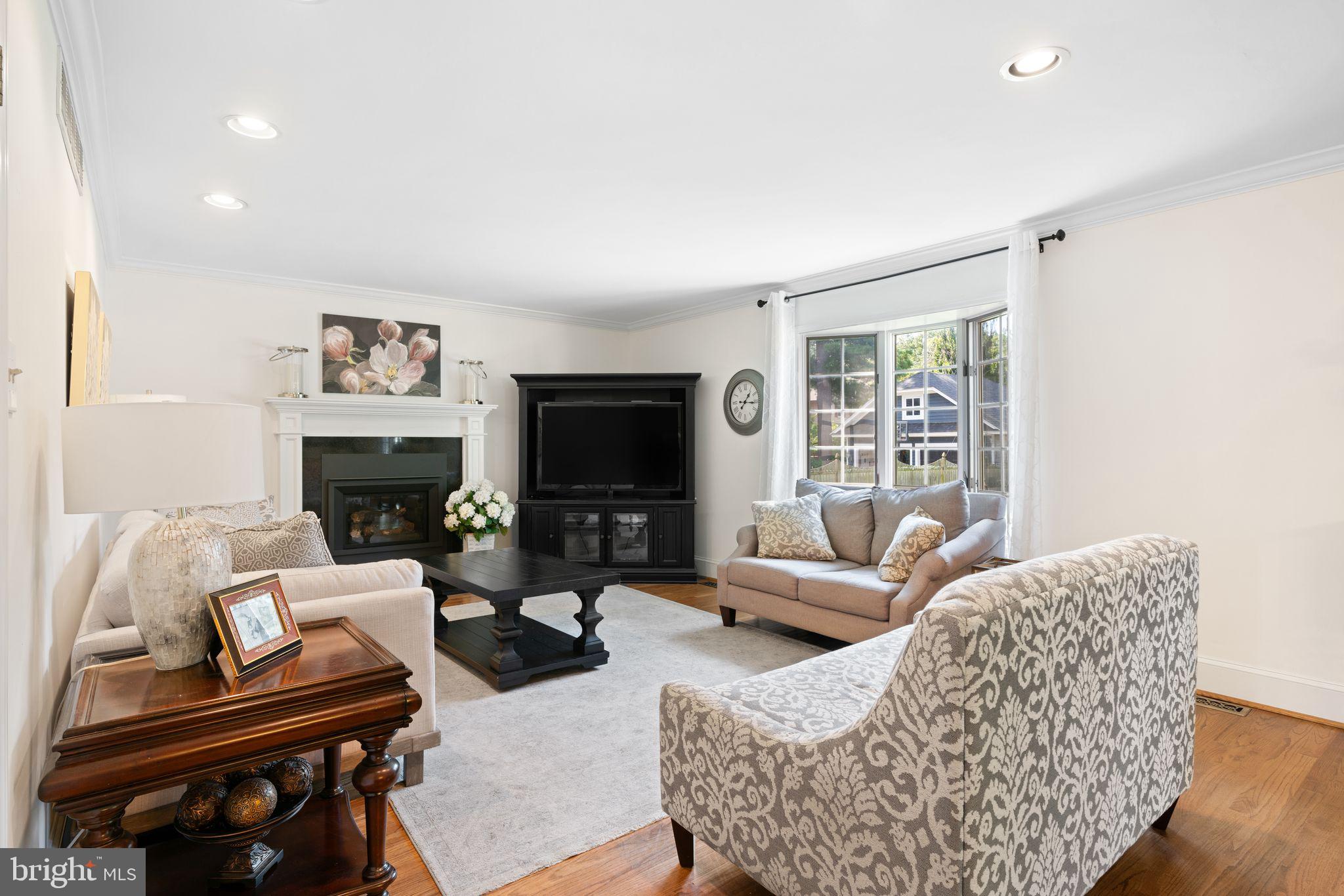 320 Warwick Road Haddonfield, NJ 08033 - Photo 12 of 41 a living room with furniture a flat screen tv and a fireplace