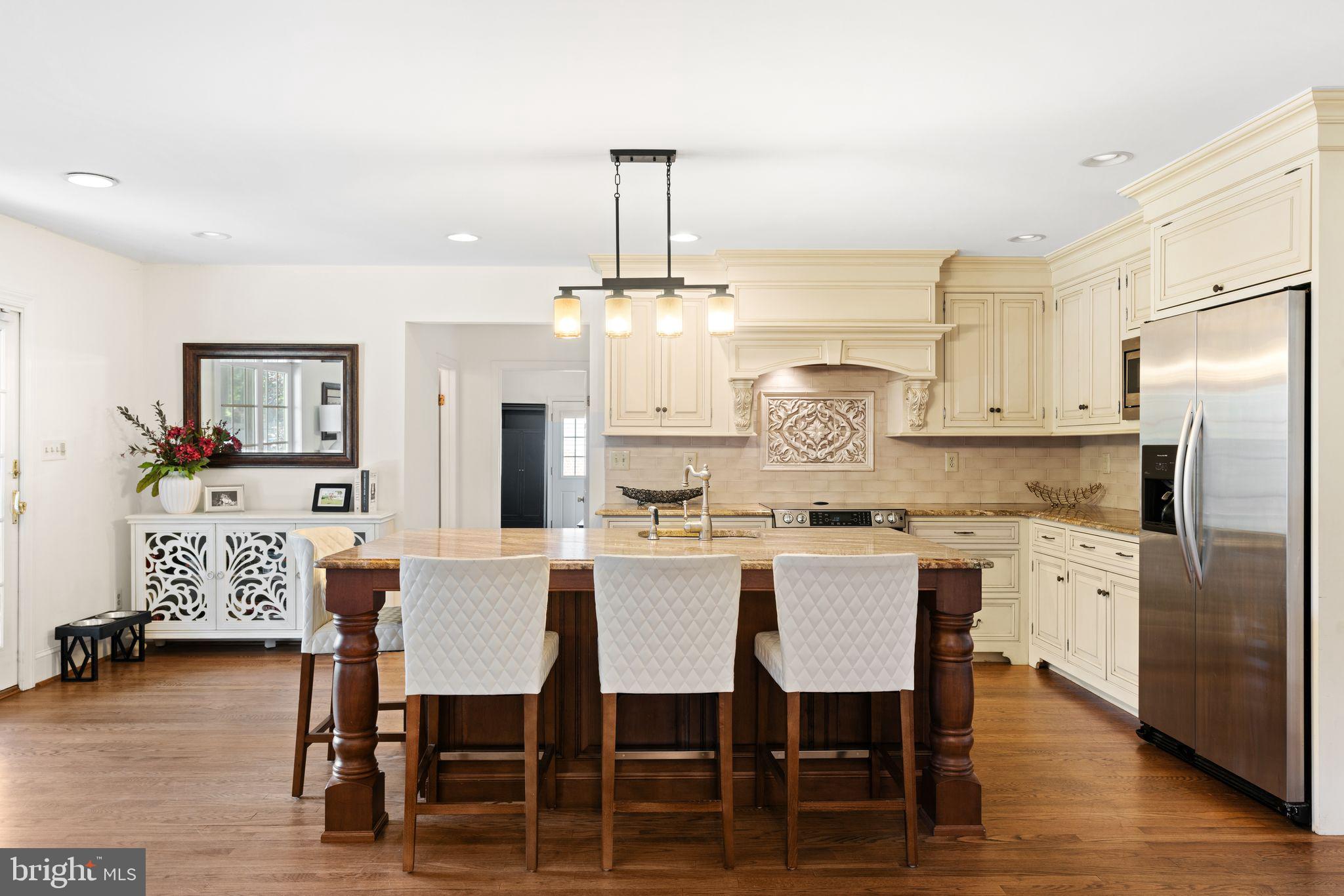 320 Warwick Road Haddonfield, NJ 08033 - Photo 9 of 41 a kitchen with stainless steel appliances granite countertop a dining table chairs stove refrigerator and cabinets