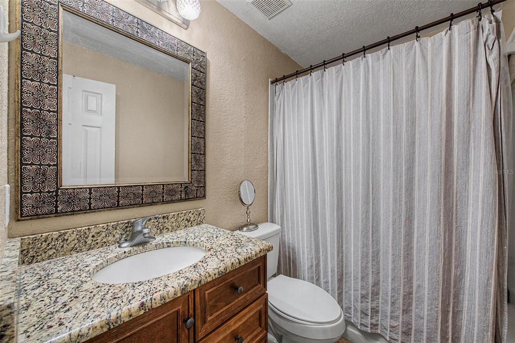 1632 Pintail Court Lutz, FL 33549 - Photo 21 of 34 a bathroom with a granite countertop sink and a mirror