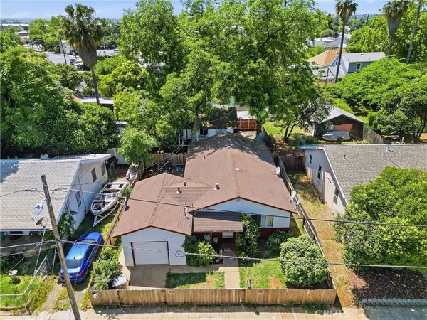 an aerial view of multiple houses with a yard