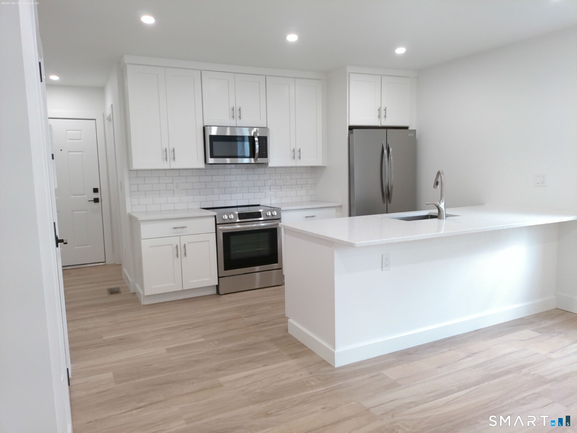 365 Broad Street, Unit 2E New Britain, CT 06053 - Photo 5 of 12 a kitchen with stainless steel appliances granite countertop a stove a sink and a refrigerator