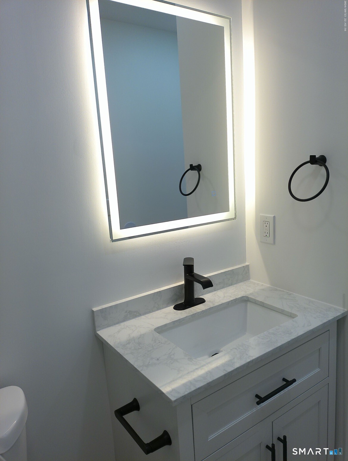 365 Broad Street, Unit 2E New Britain, CT 06053 - Photo 9 of 12 a bathroom with a sink and a mirror