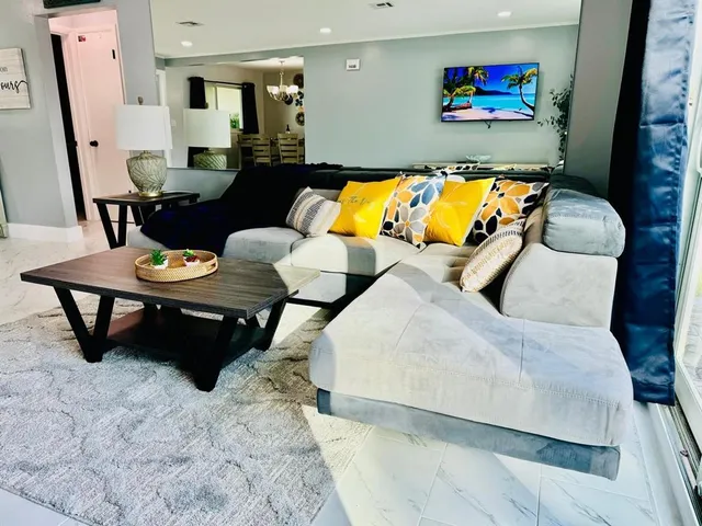 a living room with furniture and a flat screen tv