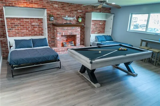 a living room with furniture pool table and window