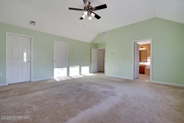 a view of empty room with ceiling fan