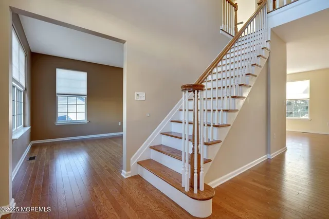 a view of entryway with wooden floor and stairs