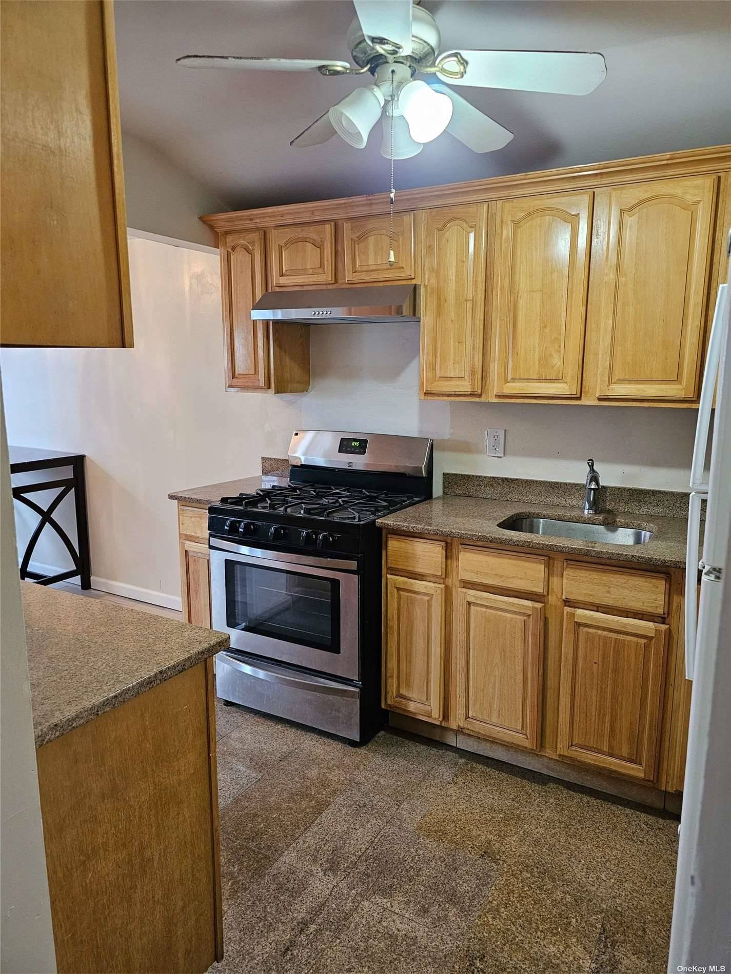 a kitchen with cabinets appliances and a window