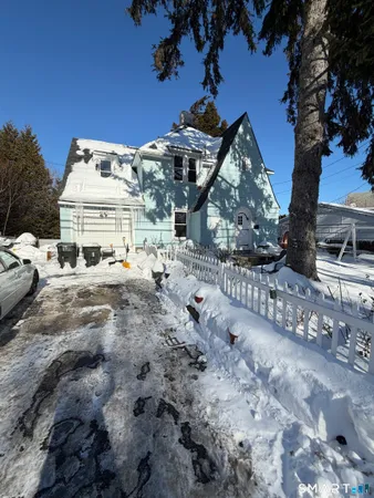 a view of a house with a snow in the yard