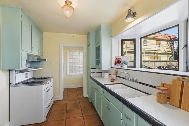 a kitchen with a sink stove and cabinets