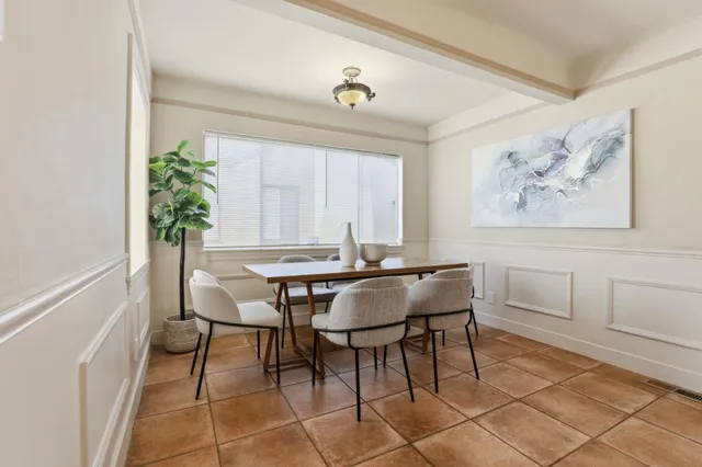 a dining room with furniture and window