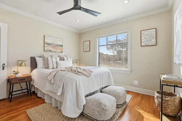 a bedroom with a bed and wooden floor