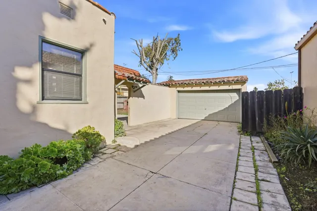 a view of a entryway door with potted plants